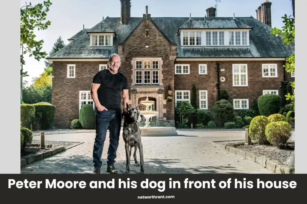 Peter Moore and his dog in front of his house