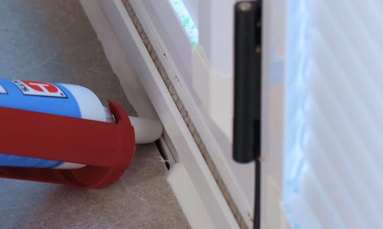 A red and white tube with a plastic handle, designed for easy grip and use